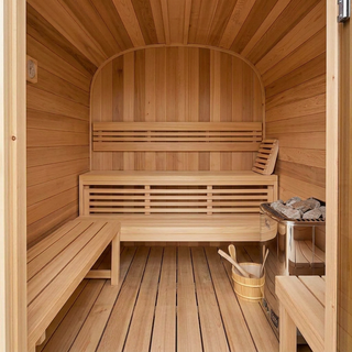 Outdoor barrel sauna interior view, wooden bench and heater